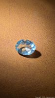 Top view of oval aquamarine on brown surface