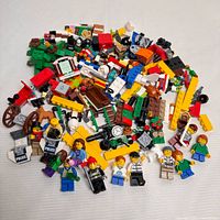 Pile of Lego minifigures and assorted parts