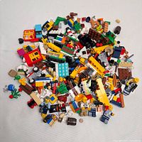 Overall pile of assorted Lego pieces and minifigure parts on white background