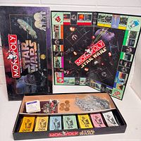 Box lid, unfolded game board, tray with money, coins, tokens visible