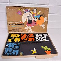 Open box showing lid graphics and trays with vinyl pieces