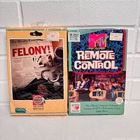Front view of both sealed game boxes