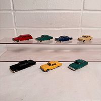 Seven INGAP cars front view on riser and table