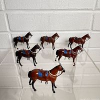 Six Britains painted metal horses front view