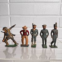 Front view of all five metal soldier figurines
