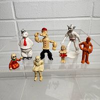 Group shot of all seven vintage plastic comic strip figures