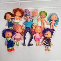Group shot of all ten Strawberry Shortcake dolls laid out on white backdrop