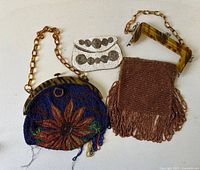 All three purses laid out showing fronts and handles