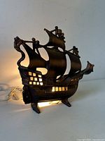 Lamp illuminated showing ship shape and glowing windows