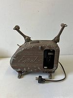 Left side view of Excel projector showing logo, side opening, reel arms folded