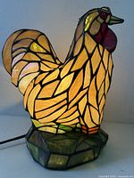 Front view of illuminated stained glass chicken lamp