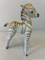 Full view of porcelain zebra foal standing