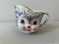 Lefton Miss Priss ceramic cat creamer front view showing facial details and floral hat