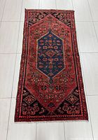 Full view of Persian Hamadan rug on tiled floor