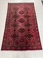 Full view of rectangular Baluch rug showing overall design and size