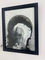 Frontal view of framed abstract splatter painting