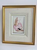 Full view of framed pinup print showing frame, mats, and artwork