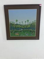 Full view of framed surrealist forest painting on wall