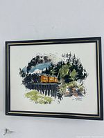 Front view of framed colour-washed ink print of steam train