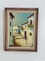 Full view of framed painting hung on wall