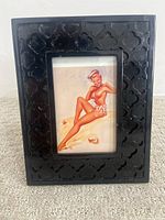 Front view of framed pinup art