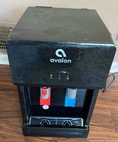 Front view showing Avalon logo, indicator lights, red and blue taps