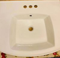 Top view of Kohler white rectangular sink showing bowl, drain hole, faucet and overflow holes
