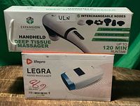 Box fronts of both massagers showing branding and models