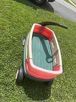 Overall view of Little Tikes plastic pull wagon on grass
