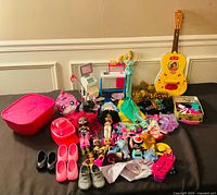 Full layout of dolls, clothes, shoes, guitar and accessories
