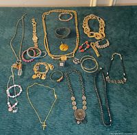 All items laid out on green surface showing full lot