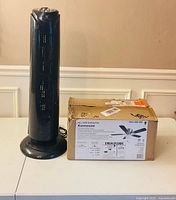 Both fans side by side showing relative sizes and tower fan condition