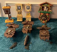 Group shot of all seven clocks arranged on carpet