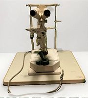 Full frontal view of W.E. Krahn slit lamp on base with power cord visible