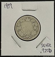 Reverse of 1899 Canadian 25 cent coin showing maple leaf wreath and date