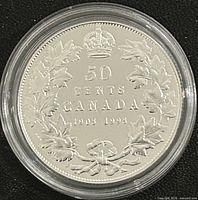 Reverse side displaying 50 Cents Canada 1908-1998 design in capsule