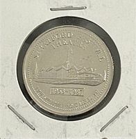 Reverse view of commemorative trade dollar in holder