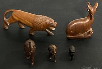 Group shot of all five wooden animal figurines