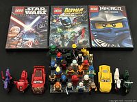 Overall lot with three DVDs, minifigures on baseplate and five vehicles