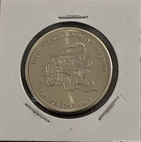 Obverse of medal showing steam tractor design and legend