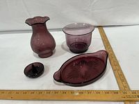 All four amethyst glass pieces with ruler for scale