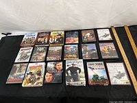 Overall view of all 20 DVD cases laid out in five rows on black backdrop