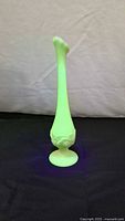 Vase glowing bright green under UV light
