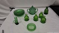 Group view of all green glass pieces on table