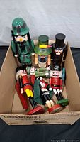 Seven nutcrackers placed in a cardboard box