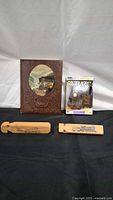 Entire lot: embossed book, DVD set, two wooden whistles