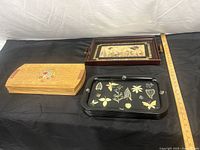 Stack of wooden veneer placemats beside trays and yardstick showing scale