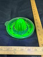 Top view of uranium glass juicer with ruler for scale