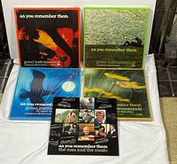 Front view of four colored box sets and booklet