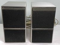 Front view of both Bang & Olufsen Beovox C40 speakers showing grille and overall condition